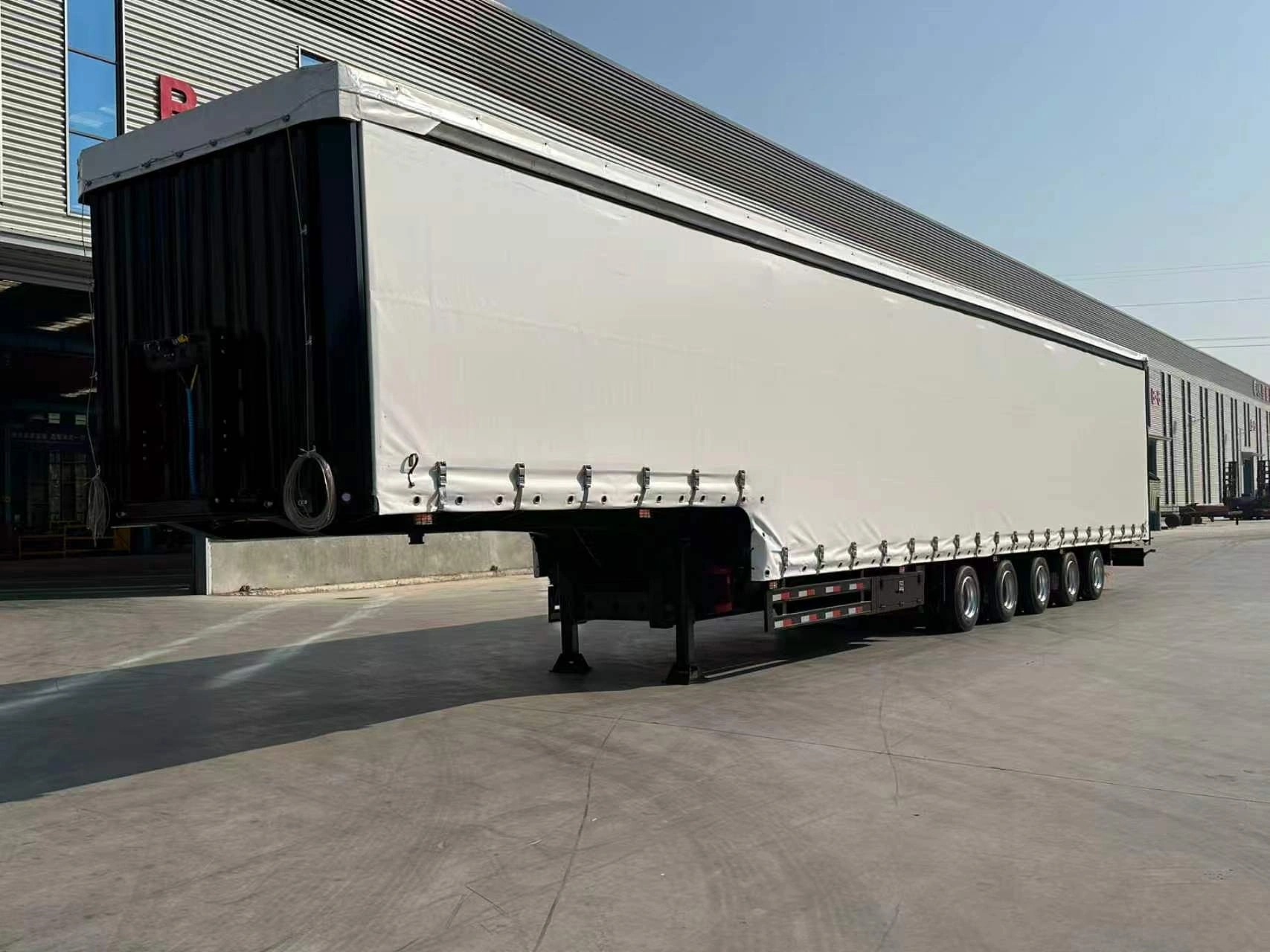 Front three-quarter view of the CHENLU 5 axle curtain side semi trailer